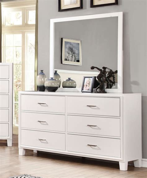 A White Dresser And Mirror In A Room