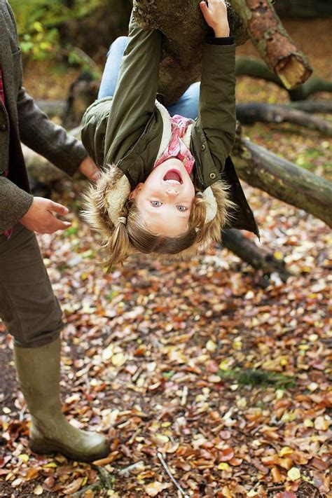 Young Girl Hanging Upside Down Photograph By Science Photo Library