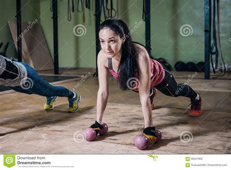 Strong Fit Woman Doing Push Ups With Dumbbells During Workout In Gym