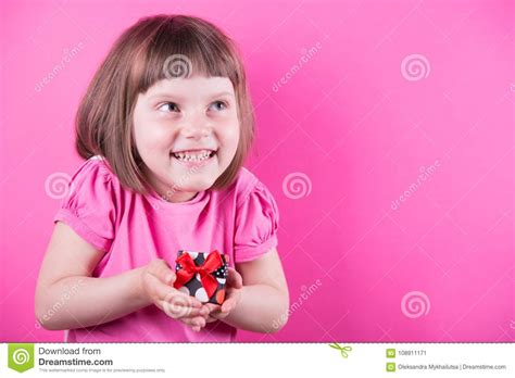 Happy Smiling Cute Little Girl Holding Pretty Spotted T Box In Her
