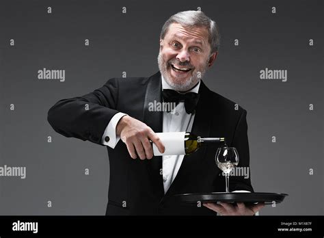 Professional Waiter In Uniform Is Serving Wine Stock Photo Alamy