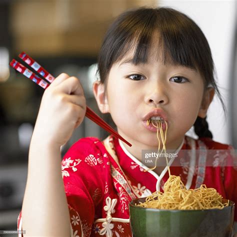 See chopsticks to learn how to use them and to learn about chopstick taboos. Girl Eating Noodles With Chopsticks Portrait Closeup Stockfoto - Getty Images