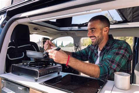 Man Cooking With A Frying Pan In His Camper Van Stock Image Image Of Male Travel 263076943