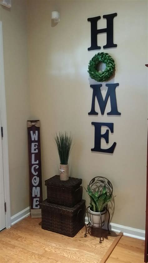 Create a personalized feature wall in your home with a mural. Wood letters HOME with wreath wall decor. | Diy living ...