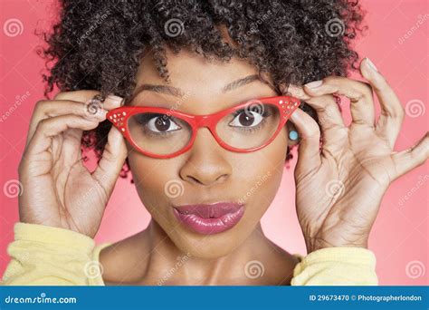 Portrait Of An African American Woman Wearing Retro Style Glasses Over Colored Background Stock