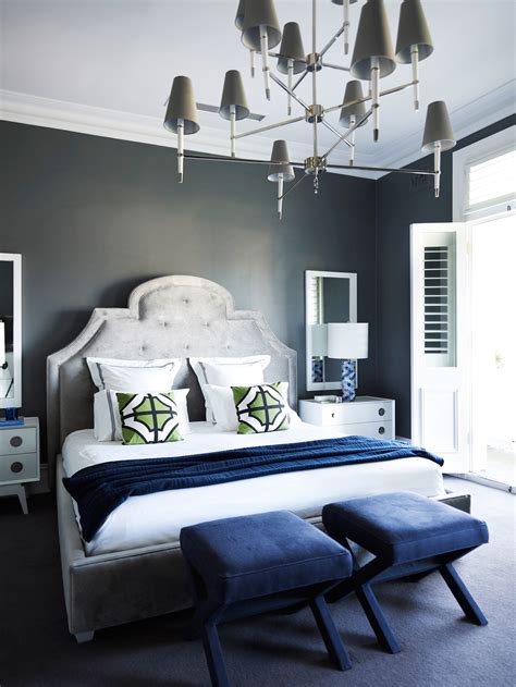 Their bold statements and daring design features beg to primary bedroom featuring sky blue walls and navy blue carpet flooring. Jonathan Adler's Favorite Home Decor Color Combo