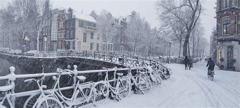 Snow In Amsterdam Does Not Keep The Dutch From Riding Thei