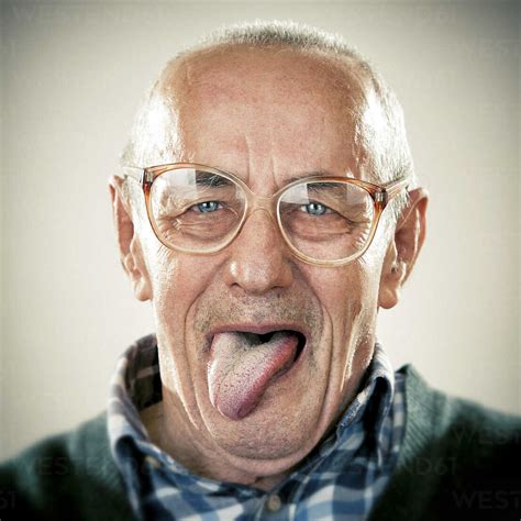 Portrait Of An Elderly Man Sticking His Tongue Out Stock Photo