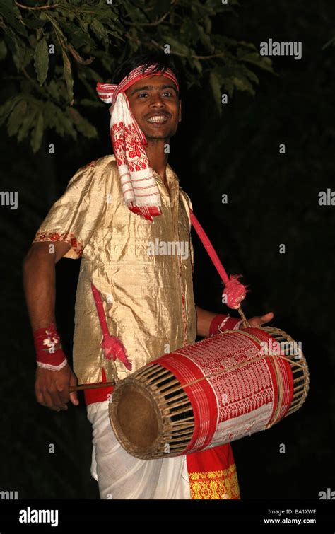 Assamese Man In Traditonal Dress Playing A Dhol Drum As Part Of A Bihu