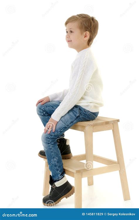 A Little Boy Is Sitting On A Chair Stock Image Image Of Comfortable