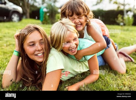 Three Girls Playing Together On A Meadow Stock Photo Alamy