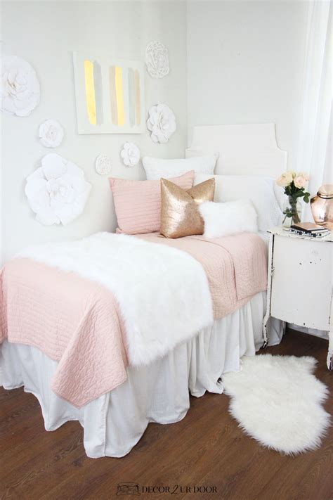 A White And Pink Bedroom With Flowers On The Wall Bedding And Rugs