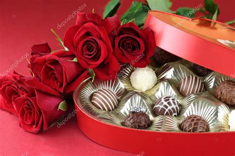 Heart Shaped Box Filled With A Variety Of Candies And Long Stem Roses