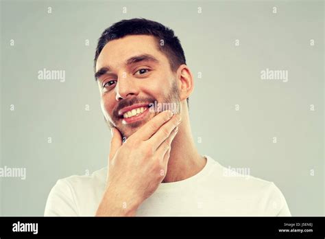 Happy Young Man Touching His Face Or Beard Stock Photo Alamy