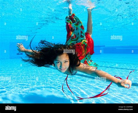 A 12 Year Old Female Teen Dressed In Colourful Dress Free Diving