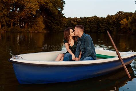 Young European Couple Is Boating On A Lake Young Man And His