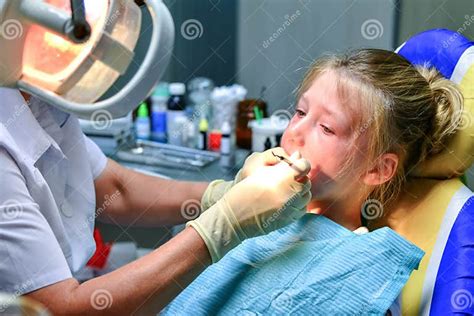 A Little Girl At The Dentist Is Crying With Tears At A Doctor S