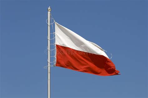 Flag Of Poland Is Seen Against The Blue Sky Stock Photo Image Of