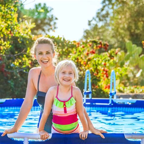 Happy Active Mother And Daughter Standing In Swimming Pool Stock Image