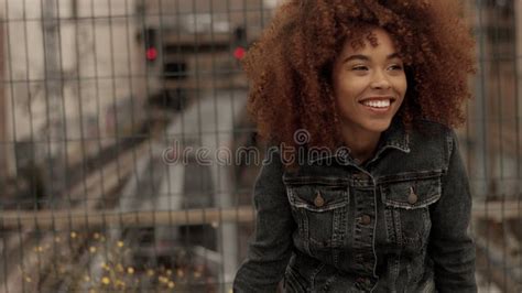 Black Mixed Race Woman With Big Afro Curly Hair In Outdoor City Stock