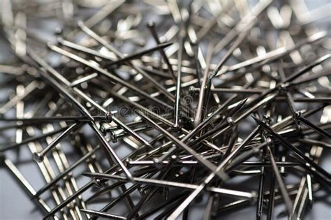 Selective Focus Of A Pile Of Nickel Plated Steel Pins Stack Of Paper