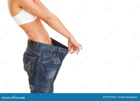 Woman Shows Her Weight Loss By Wearing An Old Jeans Isolated On Stock