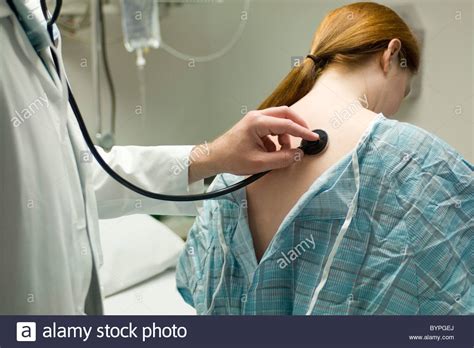 Doctor Listening To Patients Back With Stethoscope Stock Photo Alamy