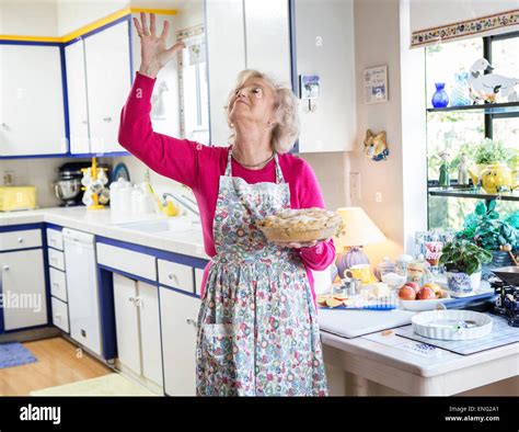 Older Caucasian Woman Baking Pie In Kitchen Stock Photo Alamy