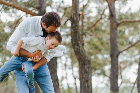 father and son have fun together in nature father and son playing people having fun outdoors