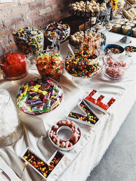 A Table Topped With Lots Of Different Types Of Candies And Desserts