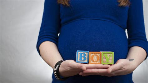 Pregnant Woman Carrying Low Showing Blocks Of Boy Famlii