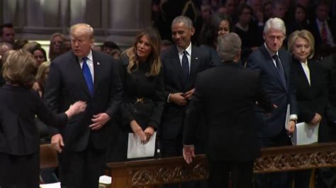 sweet moment george w bush slips michelle obama another piece of candy during funeral