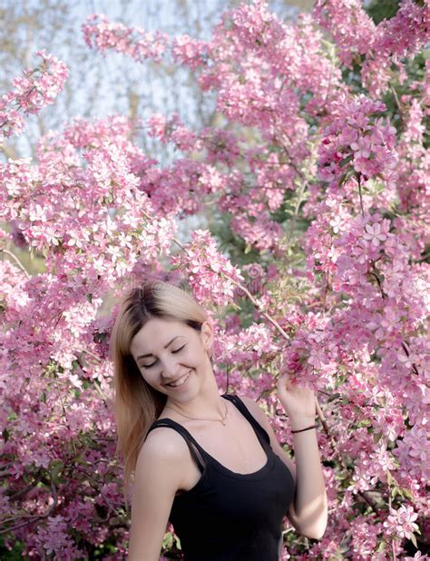 Beautiful Smiling Young Woman Near The Blossoming Spring Tree Portrait Of Pretty Blond Girl