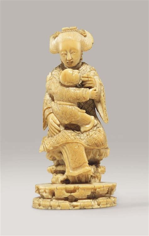A Carved Ivory Figure Of A Female Attendant And Child 18th Century
