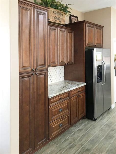 This color combination works well with green or gray accents, whether in the form of a kitchen counter herb garden or stainless steel appliances. Chocolate Maple Glazed in 2020 | Built in cabinets, Metal shelves, Home