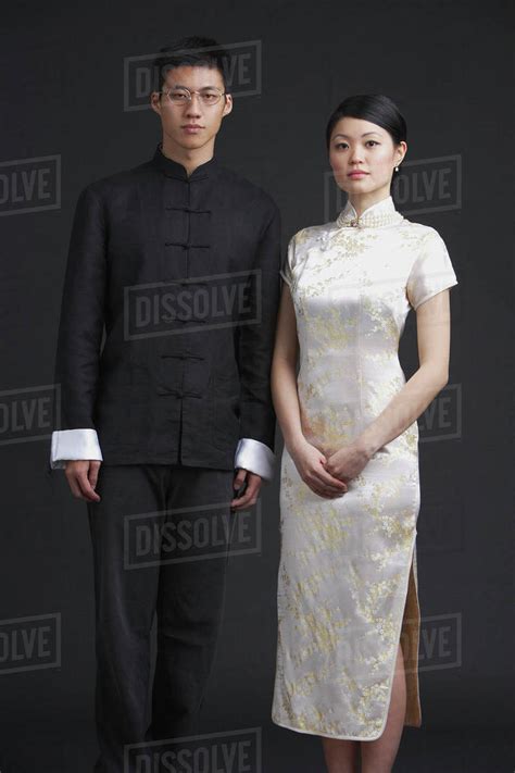 Couple Dressed In Traditional Chinese Attire Posing For Studio