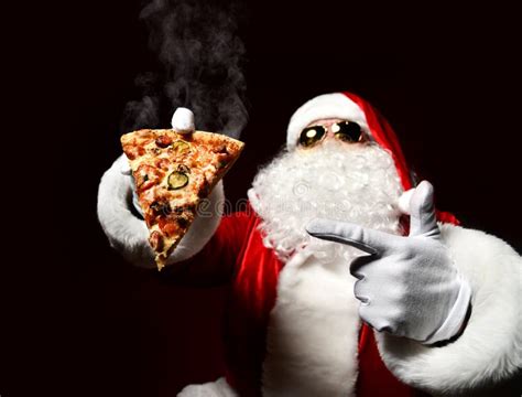Happy And Generous Santa Claus Is Holding Tasty Pizza On His Open Palm