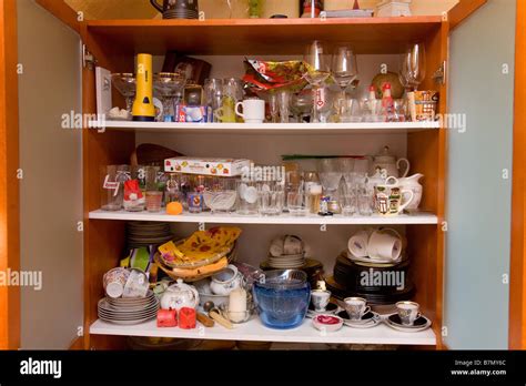 Messy Kitchen Glass Cabinet With Dishes Stock Photo Alamy