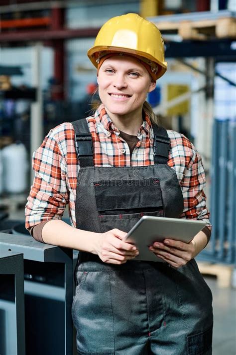 Young Successful Female Engineer With Tablet Standing In Front Of