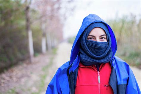 Front View Of A Woman Wearing A Ski Mask While Standing Outdoors And
