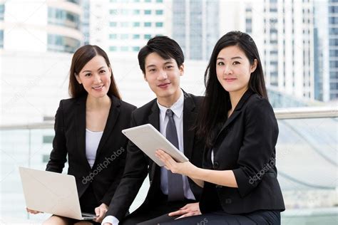 Asian Business People Work Together At Outdoor Stock Photo By