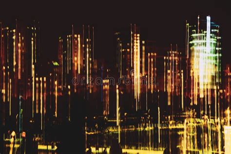 Blurred Skyscrapers Against Dark Sky Buildings At Night Illuminated