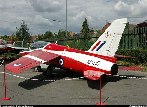 A Small Red And White Plane Is On Display