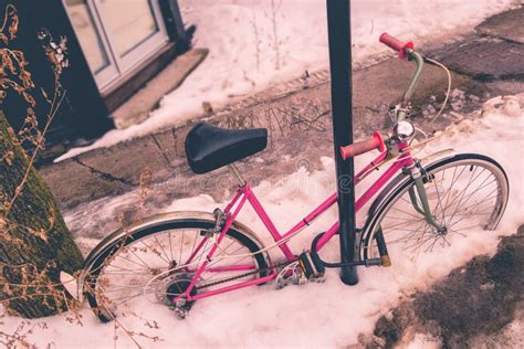 Vintage Picture Of A Pink Bike Covered In Snow During Snow Storm Stock