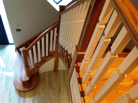 Contemporary White Oak And Ivory Cut String Flared Stairs With Paneling
