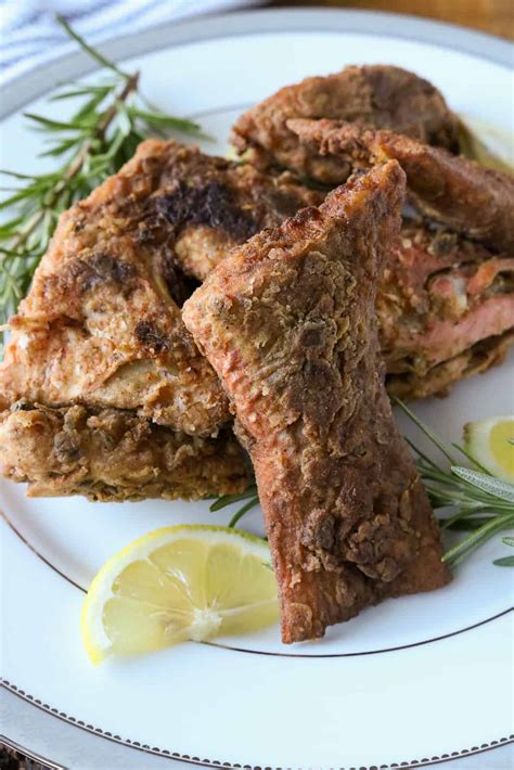 Snapper or other white, firm fish, soaked in egg, mustard and seasoning, dusted in saltines. Fried Red Snapper - Haitian Style - Savory Thoughts
