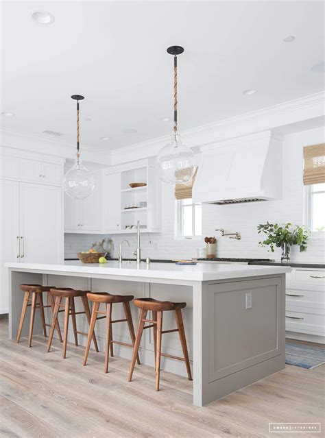 White Kitchen With Gray Island And Brown Wood Bar Stools Interior