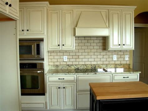 Distressing cabinet surface to achieve the antiquing look. Painted, Distressed Kitchen Cabinets - Traditional ...