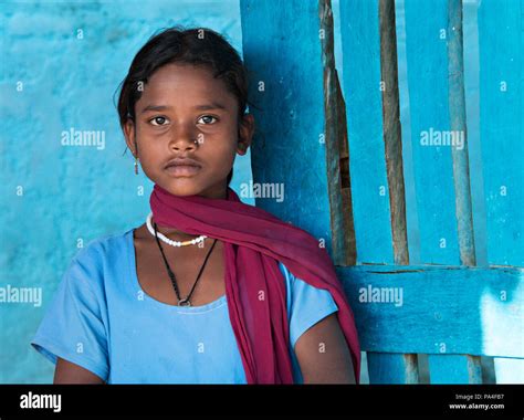 Beautiful Indian Girl Portrait Wearing Blue Top Against A Blue Wall In Kanha Village Near The