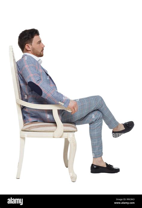 A Man In A Suit Is Sitting On An Expensive Chair Side View Of A Guy In